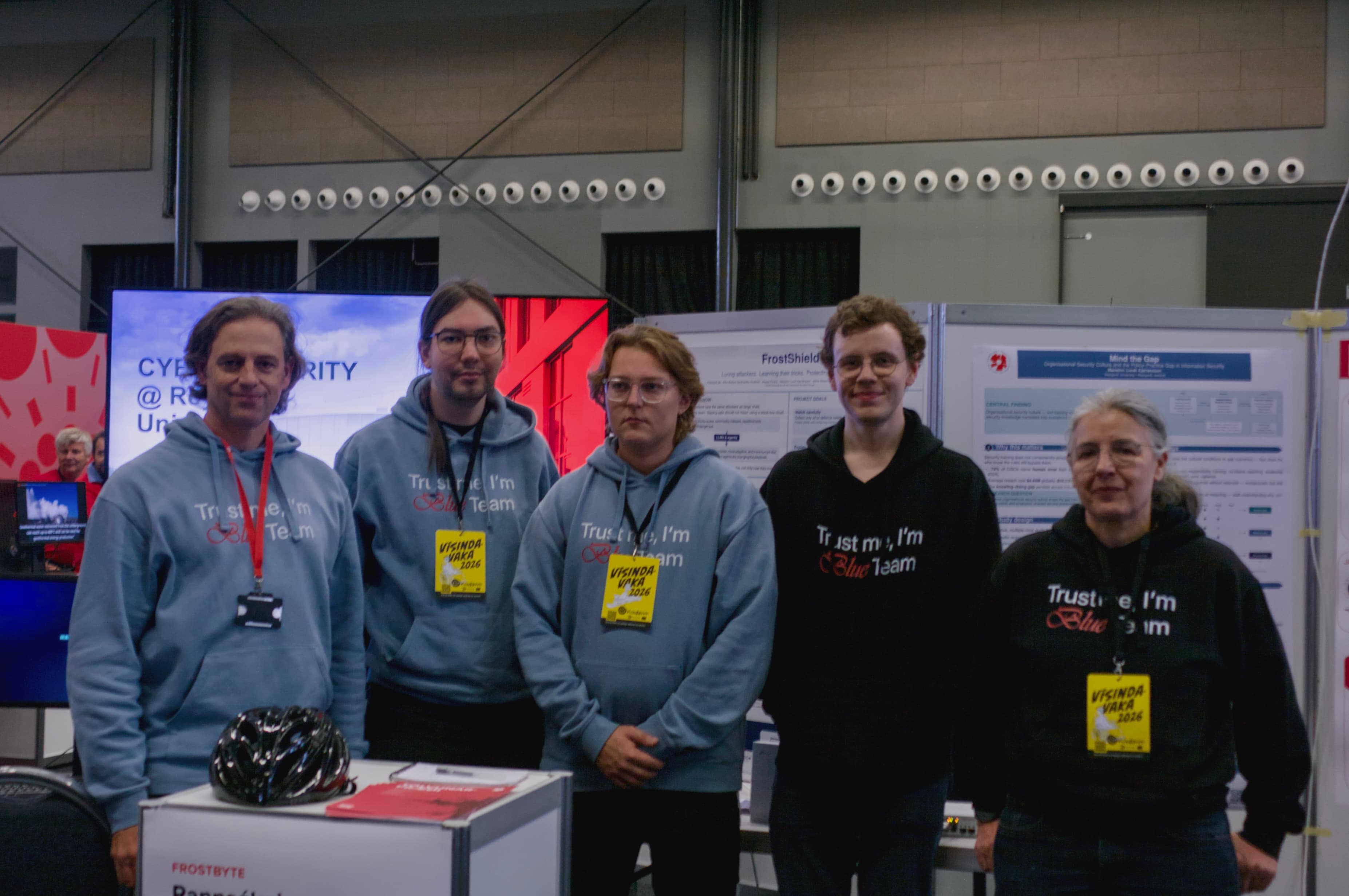 Five Frostbyte lab members posing at their Vísindavaka 2026 booth, with research posters behind them.