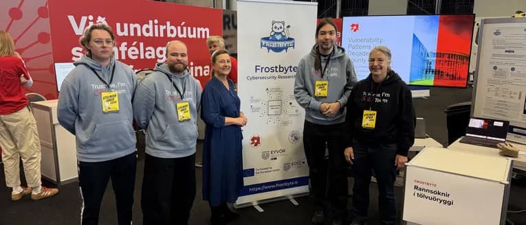 Clara Ganslandt with Frostbyte lab members beside the lab’s banner and cybersecurity displays at Vísindavaka 2026.